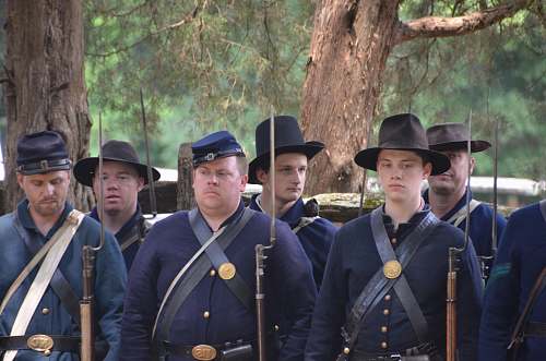 human group of men standing near tree apparel