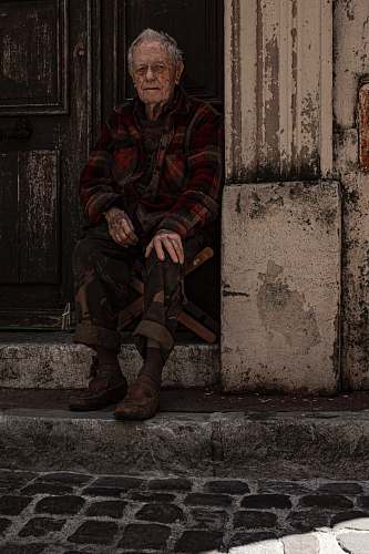 human man sitting on folding chair beside door military