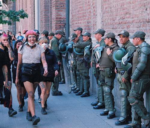 human people walking in front of officers on street apparel