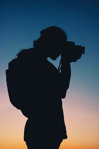 human silhouette of person using camera photography