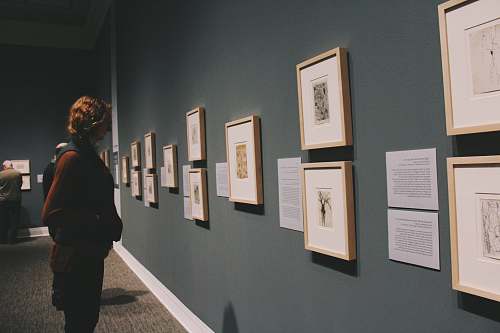 art woman looking at wall frames human