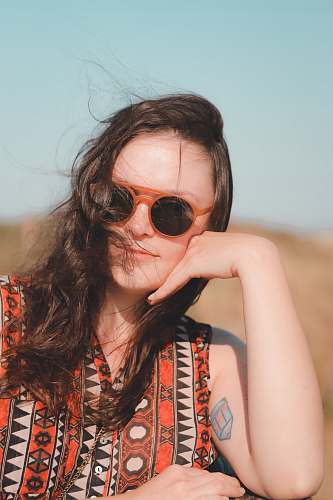 people woman wearing sunglasses and orange shirt human