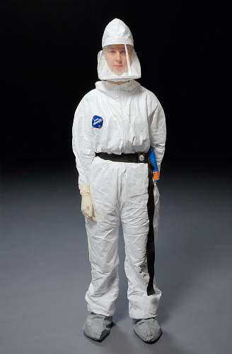 medical person wearing white overalls air purifying respirator