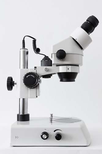 black-and-white white and black microscope on white surface microscope