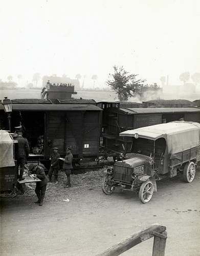 transportation greyscale photo of vehicles beside train truck