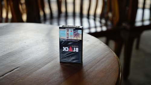 hardwood Black cigarette box on top of brown wooden table furniture