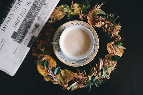 ticket white ceramic teacup filled by coffee on top of saucer plate text