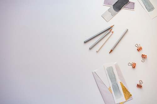 background high angle photo of four pencils and greeting card grey