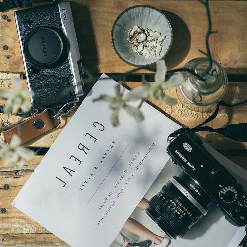 camera white printer paper between two black DSLR cameras cereal