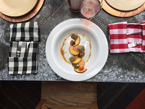 breakfast fruit slice on white ceramic plate in the middle of handkerchiefs meal