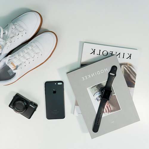 camera pair of white low-top shoes electronics