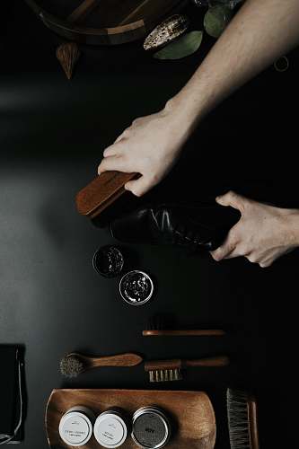 person brown and black brush shoe care