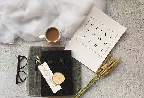 faith white ceramic mug near black-framed eyeglasses hope