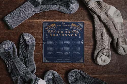 knitting pair of gray socks and blue calendar on table socks