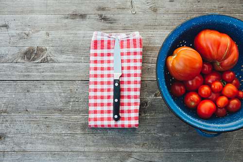 bowl silver knife with black handle tomato