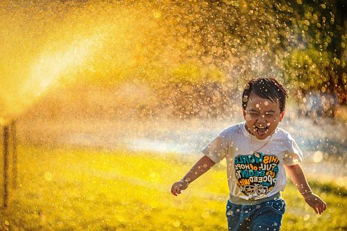 a little boy running through a puddle