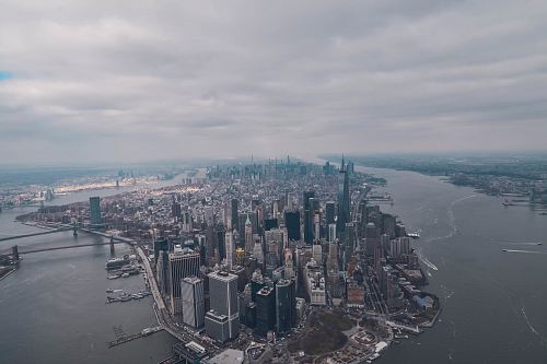aerial photo of high rise buildings surrounded by sea during daytime