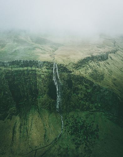 aerial photo of waterfalls during foggy weather