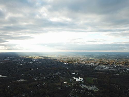 aerial photography of field under white and gray skies