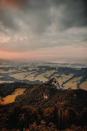 aerial photography of tree covered mountain under gray skies
