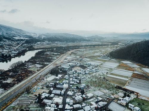 aerial photography village houses near mountains during daytime