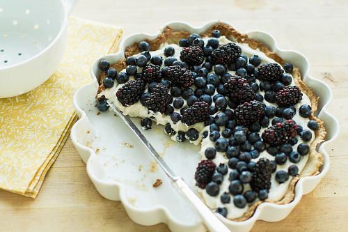 blueberry pie on plate with knife
