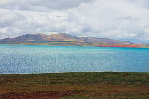 body of water and brown mountain range