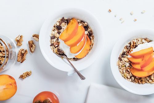 bowl of cereal with sliced fruits and spoon