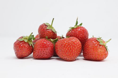 bunch of strawberries in white surface