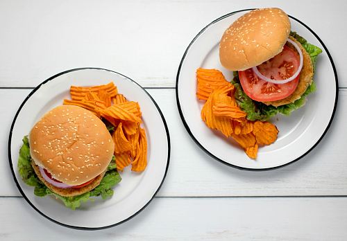 burger dish on round white ceramic plates