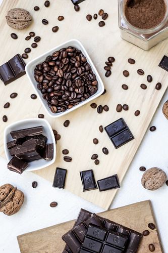chocolate and coffee seeds on table near bowls