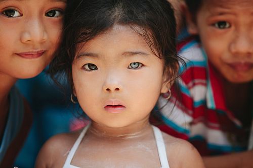 girl standing beside children