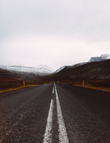 gray asphalt road under cloudy sky