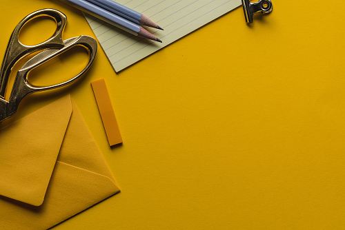 gray scissor with envelope and pencils