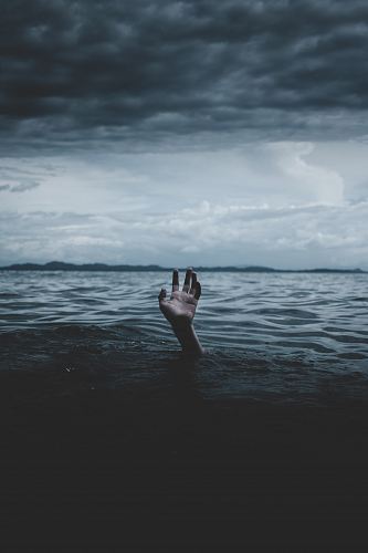 grayscale photography of hands under body of water