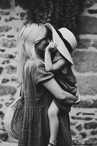 grayscale photography of woman carrying girl