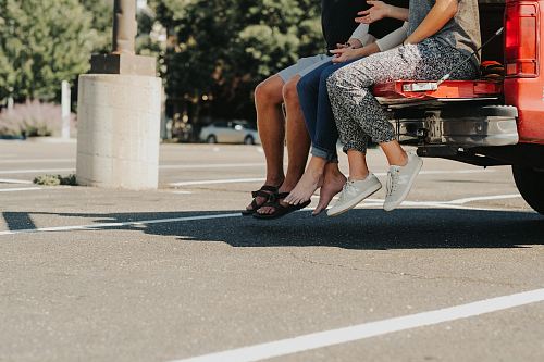 group of people sitting on truck bed