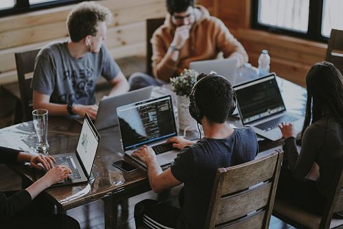 group of people using laptop computer