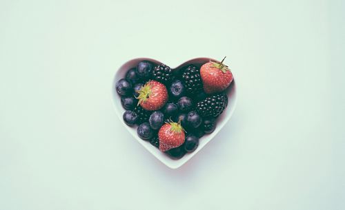 heart-shaped bowl with strawberries