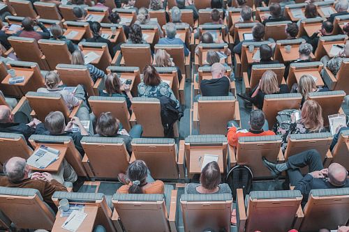 high-angle photography of group of people sitting at chairs