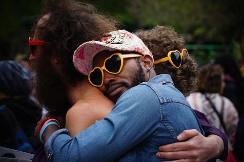 man hugging other man's back