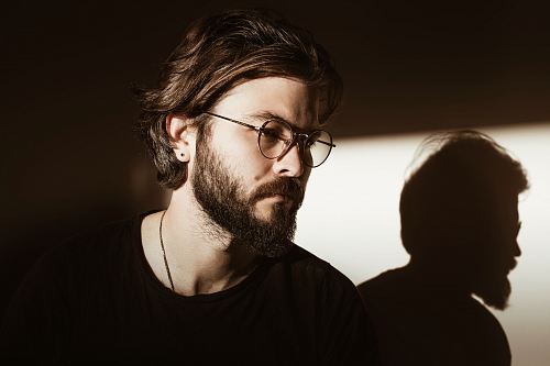 man in black crew-neck shirt wearing eyeglasses