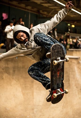 man riding skateboard and doing ollie trick