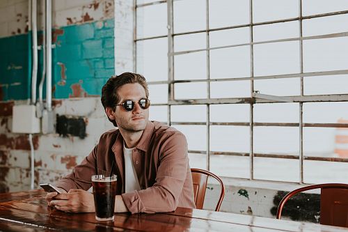 man sitting on chair holding phone