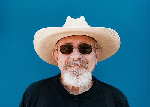 man standing near blue wall