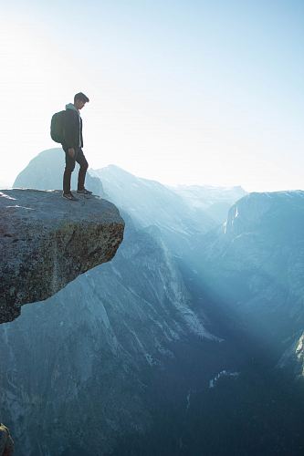 man standing on cliff