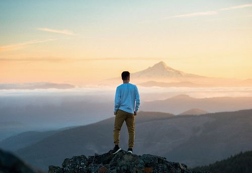 man standing on top of mountain