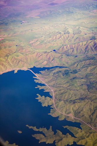 mountains beside body of water in aerial view photography