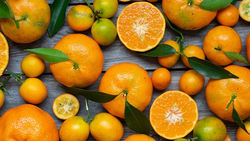 orange fruits on gray wooden surface
