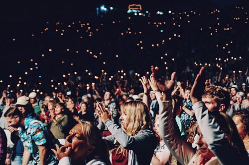 people racing smartphones on concert